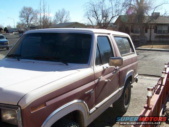 Brown and white Ford Bronco, side view, showing two-tone paint and chrome trim