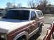 1981 Ford Bronco - A two-tone brown and white Ford Bronco is parked on a street, viewed from the front quarter angle.
