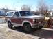 1981 Ford Bronco - This 1981 Ford Bronco features a two-tone red and white paint scheme and a prominent grille.