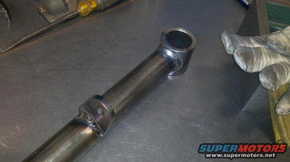Welded metal tube part with a circular opening at one end