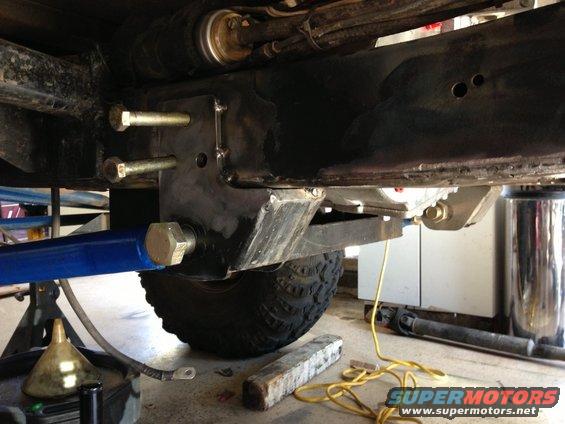 close-up of modified suspension components and frame of a vehicle