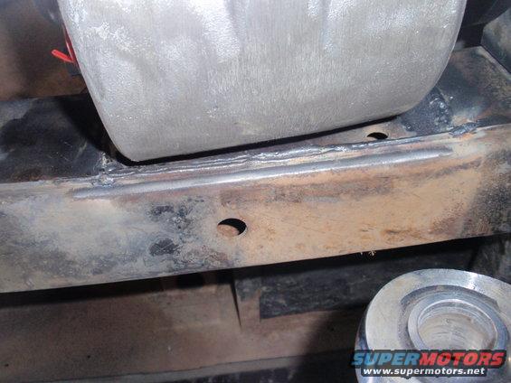 Close-up of rusty frame with a metal suspension component