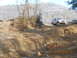 1986 Ford Bronco - A 1986 Ford Bronco navigates a challenging, muddy off-road course on a clear day.