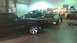 1973 Chevrolet Camaro - Multiple vehicles are present in a workshop setting, with one car in the foreground and two others in the background.