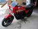 2008 Ford Crown Victoria - This red Kawasaki GPz1100 motorcycle is parked in a garage with boxes in the background.