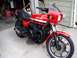 2008 Ford Crown Victoria - A red Kawasaki GPz 1100 motorcycle is parked in a garage, showing its front three-quarter view.