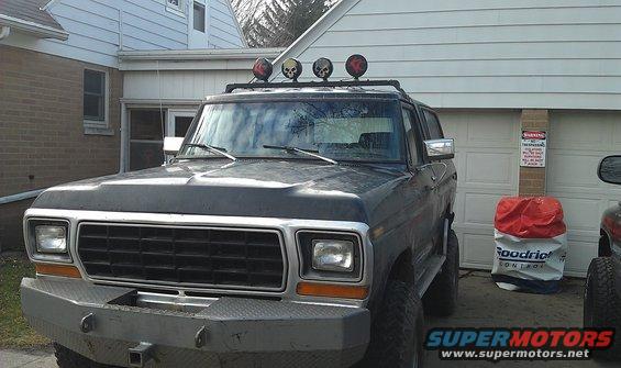 Dark blue 1978 Ford Bronco with aftermarket bumper and roof lights