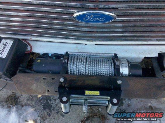 Ford oval badge on chrome grille, with a winch mounted below