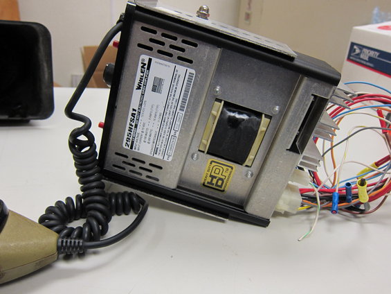Siren control box with "WHILEN" label and coiled cord