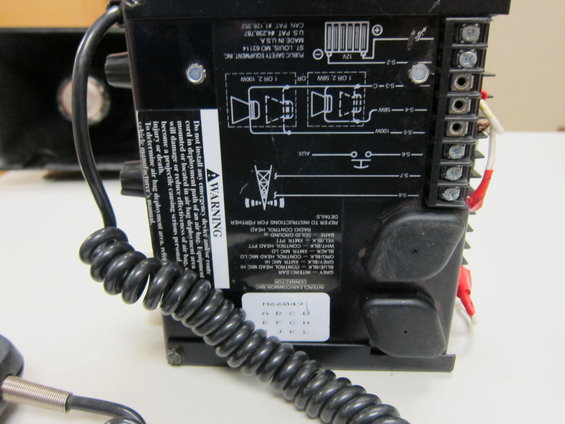 Black siren control unit with wiring diagram and warning label