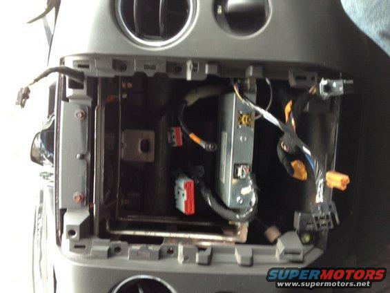 Dashboard interior with wiring harness and radio cavity exposed