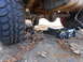 1986 Ford Bronco - Vehicle undercarriage with a jack and debris on the ground. Date stamp shows 02/02/2012.