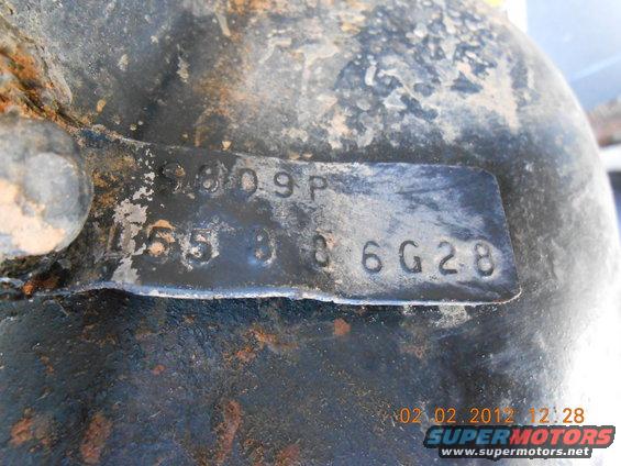 Close-up of a metal part with stamped numbers: 9809P and 4653006G28