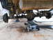 1986 Ford Bronco - The rear axle assembly of a vehicle is shown supported by jack stands and a floor jack.
