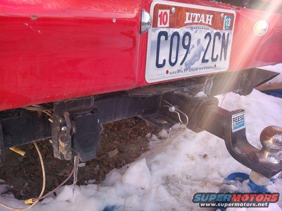 Red vehicle rear with trailer hitch and Utah license plate C09-2CN