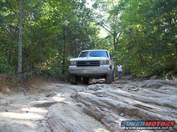 White 1990 Ford Bronco front view on rocky trail