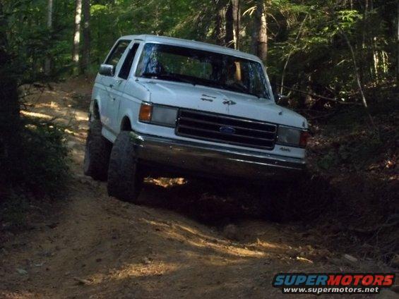 White 1990 Ford Bronco on a dirt trail