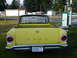 1961 Ford Ranchero - A yellow pickup truck is parked on grass, with a '4 SALE 30' sign on the rear window.