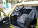 1961 Ford Ranchero - The interior of a 1961 Ford Ranchero features a two-tone bench seat, aftermarket steering wheel, and a dashboard with a horizontal speedome…