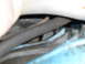 1961 Ford Ranchero - A close-up view shows a dark hose and various metal components, likely from a vehicle's engine bay or undercarriage.