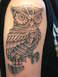 1972 Ford Pinto - A detailed steampunk owl tattoo adorns an arm, intricate gears and metallic plating.