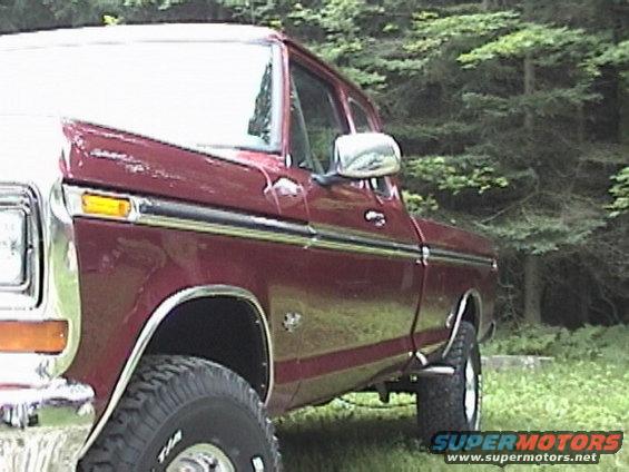 1979 Ford F-150 pickup truck, side view, red paint, chrome trim, off-road tires
