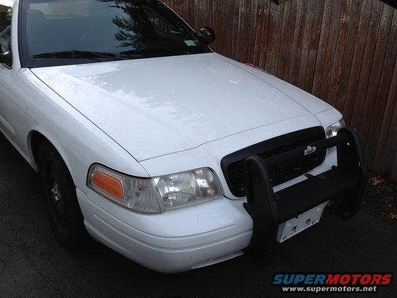 White 2007 Ford Crown Victoria front view with black push bar and grille