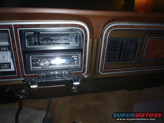 1979 Ford Bronco interior dashboard with woodgrain trim and aftermarket JVC stereo
