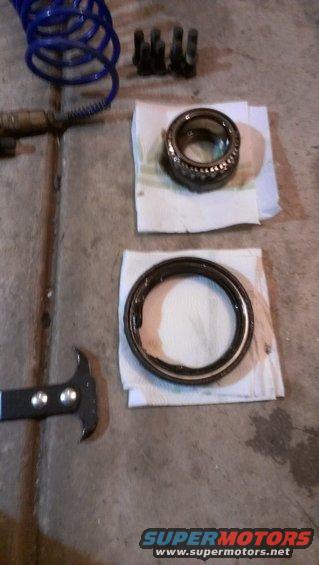 Wheel bearings and seal puller on concrete floor