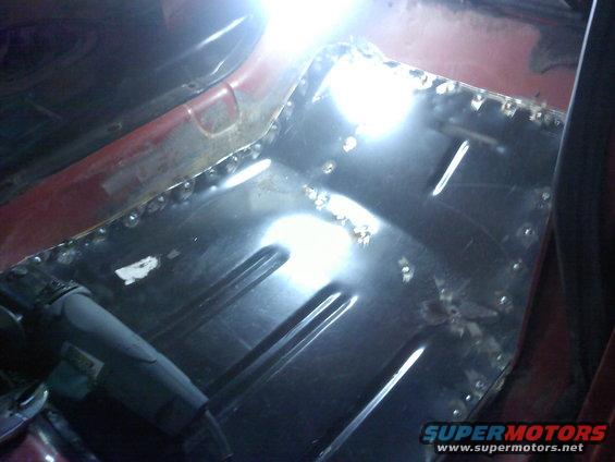 Interior view of a vehicle's floor pan being repaired with welding