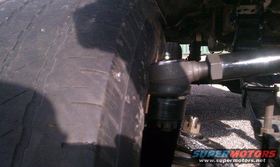 Close-up of a tie rod end and tire tread