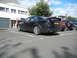 2003 Mercury Marauder - Black sedan with spoiler and dual exhaust pipes parked in a lot.