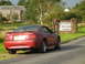 2003 Mercury Marauder - A red Ford Mustang is parked beside a sign welcoming visitors to England's Cumbria region.