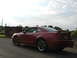 2003 Mercury Marauder - A red coupe is seen near a stone sign that reads 'Scotland welcomes you'.