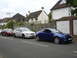 2003 Mercury Marauder - Blue Ford Puma coupe parked on a residential street with other cars.