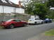 2003 Mercury Marauder - Three cars are parked on a residential street. The closest is a red Ford Mustang.