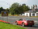 2003 Mercury Marauder - A red Ford Mustang GT is seen near a sign welcoming visitors to Scotland.