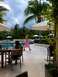 1960 Ford Falcon - A resort scene with people by the pool under a cloudy sky.