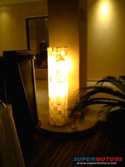Interior scene with a tall, cylindrical lamp illuminated