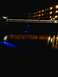 1960 Ford Falcon - Night scene of a hotel and its reflection in the water, with blue underwater lights visible.