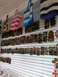 1960 Ford Falcon - A variety of colorful bags and carved wooden masks are displayed on a slatted wall in a shop.