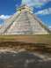 1960 Ford Falcon - The ancient Mayan pyramid of El Castillo stands tall against a bright blue sky at Chichen Itza.