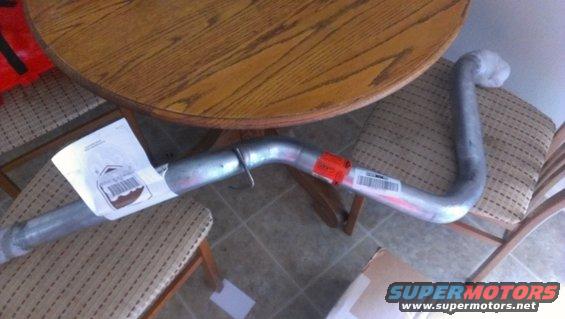 Exhaust pipe with labels on a chair next to a wooden table