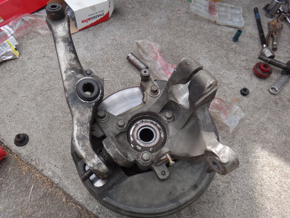 Suspension knuckle with brake rotor and control arm attached