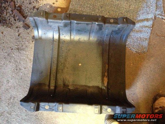 black plastic undercarriage shield with mounting holes