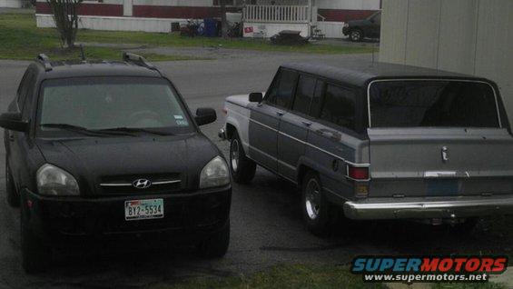 1982 Jeep Wagoneer and a black Hyundai Tucson parked next to each other