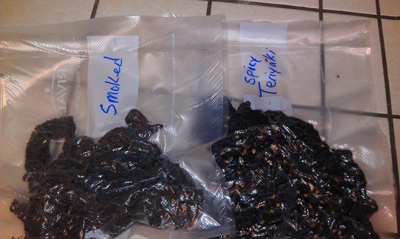 Two vacuum-sealed bags of jerky, one labeled 'Smoked' and the other 'Spicy Teriyaki'