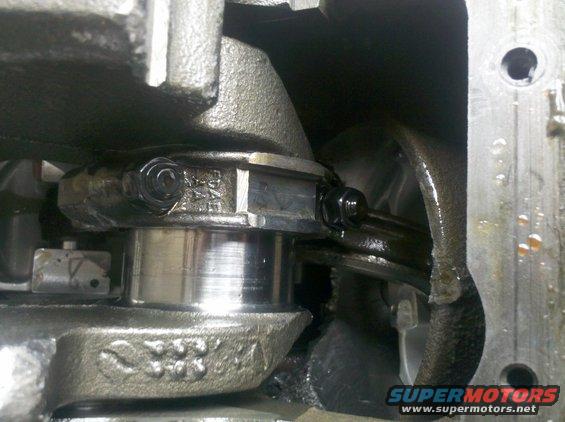 Close-up of engine crankshaft with connecting rod attached