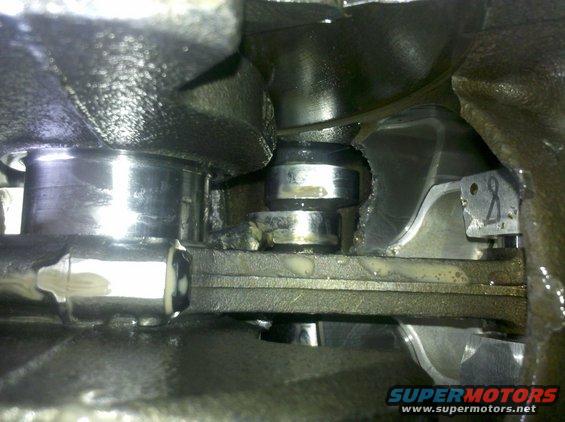 Close-up of engine's crankshaft and connecting rod with visible wear