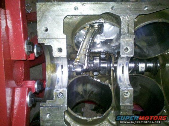 Engine block with broken connecting rod and damaged crankshaft bearings